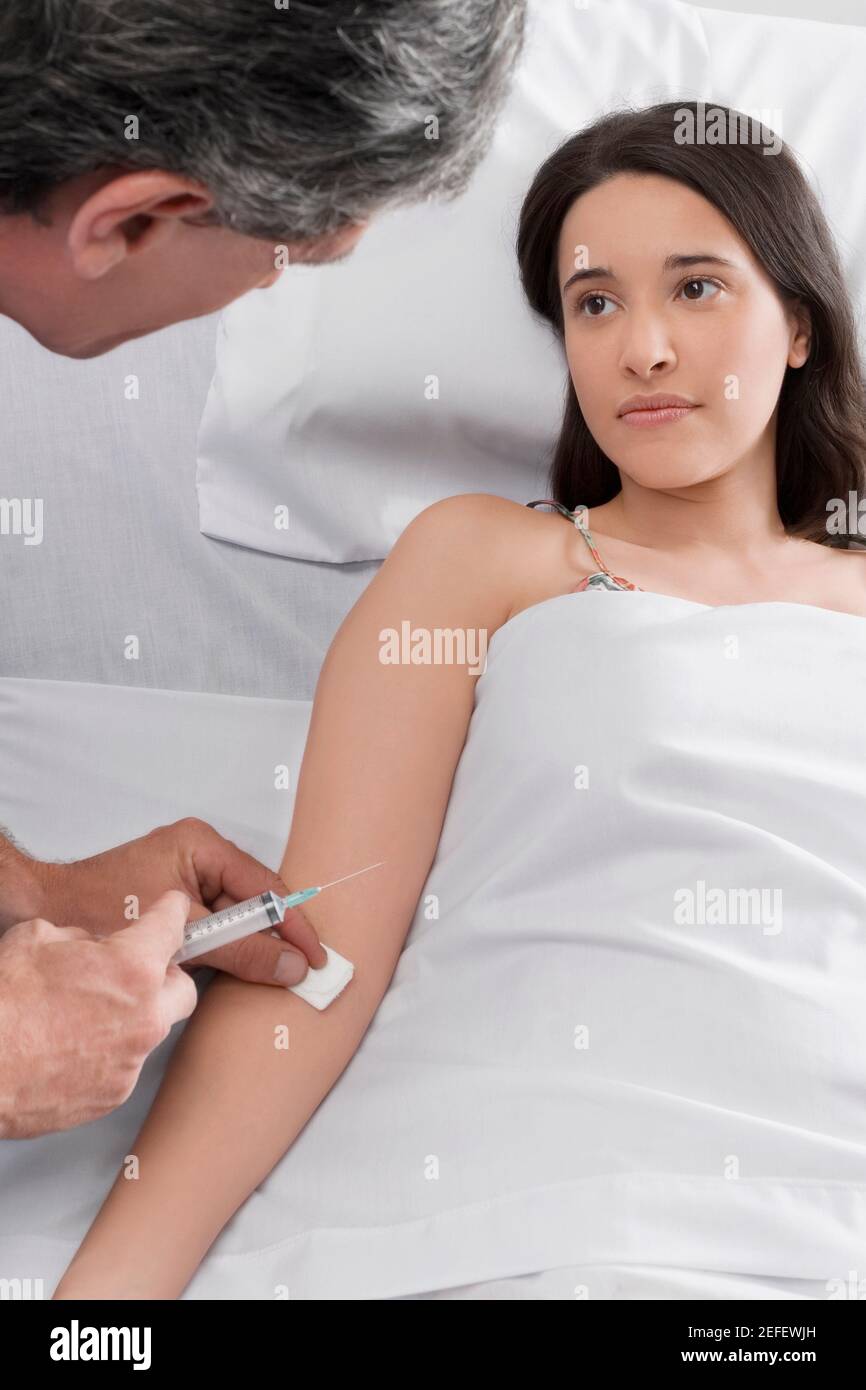 Male doctor giving an injection to a female patient Stock Photo Alamy