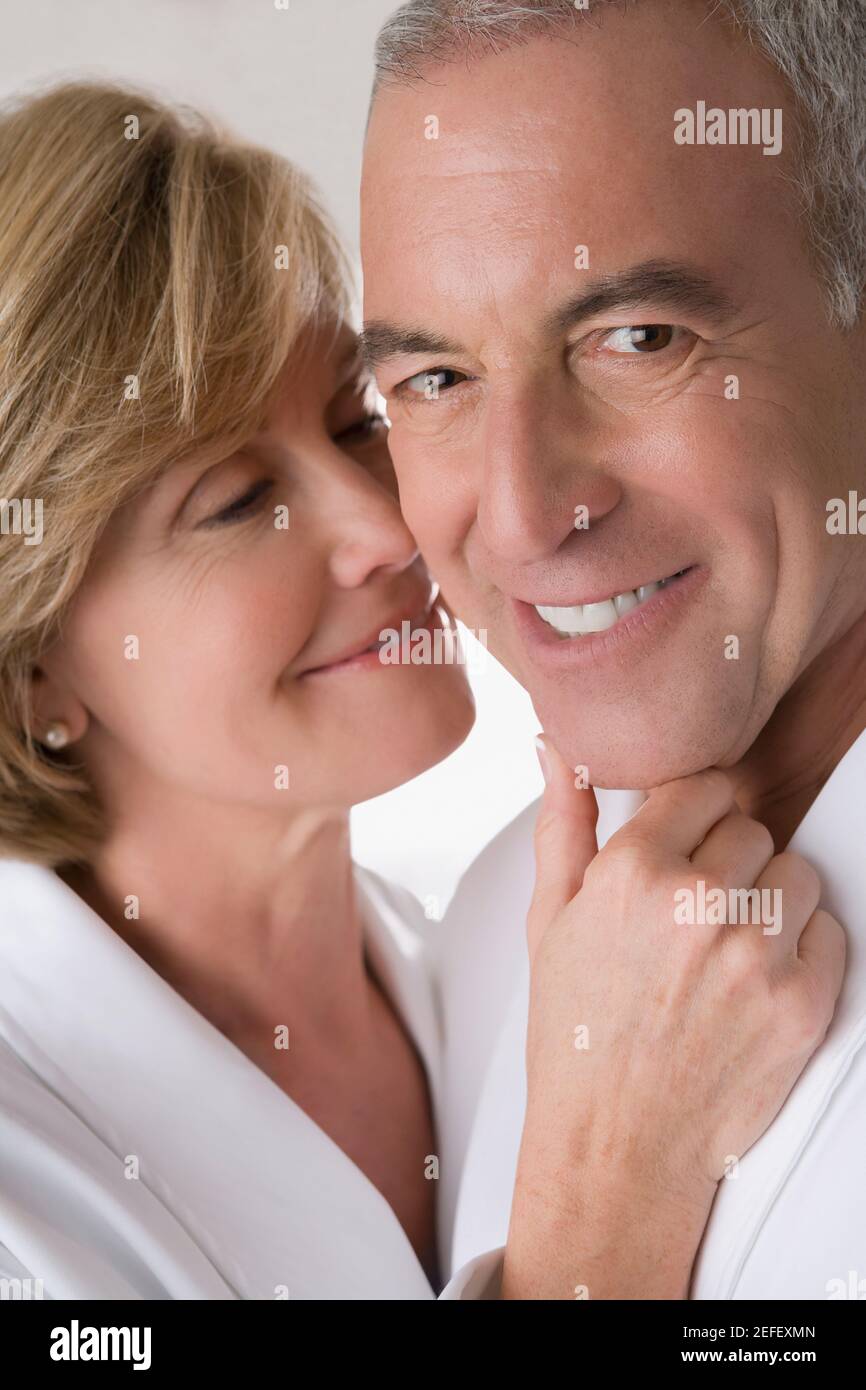 Close up of a mature woman romancing with a senior man and smiling Stock Photo