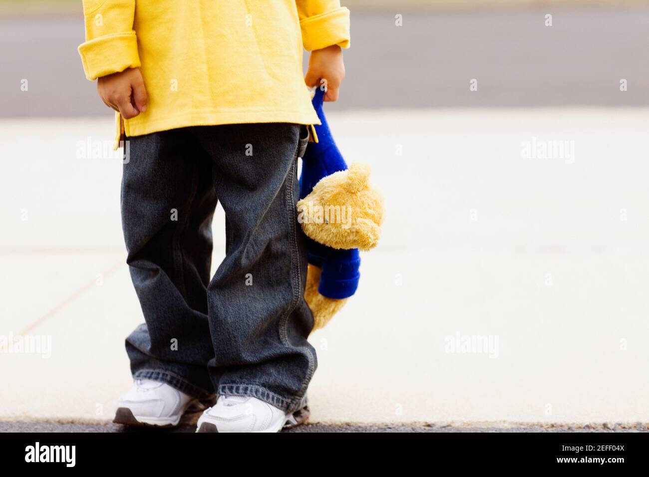 Low section view of a boy holding a teddy bear Stock Photo - Alamy