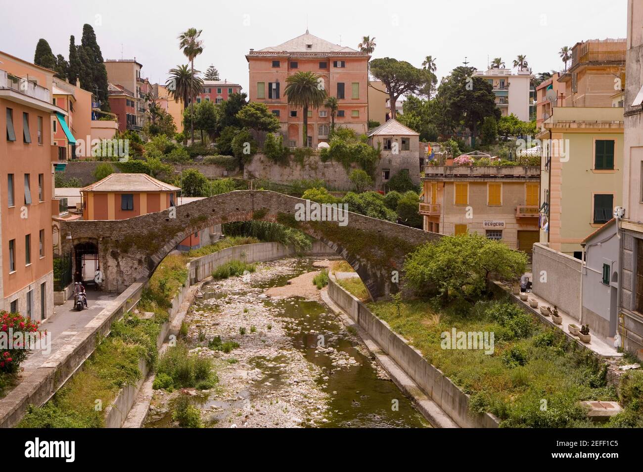 Arch bridge near buildings, Genoa Province, Liguria, Italy Stock Photo