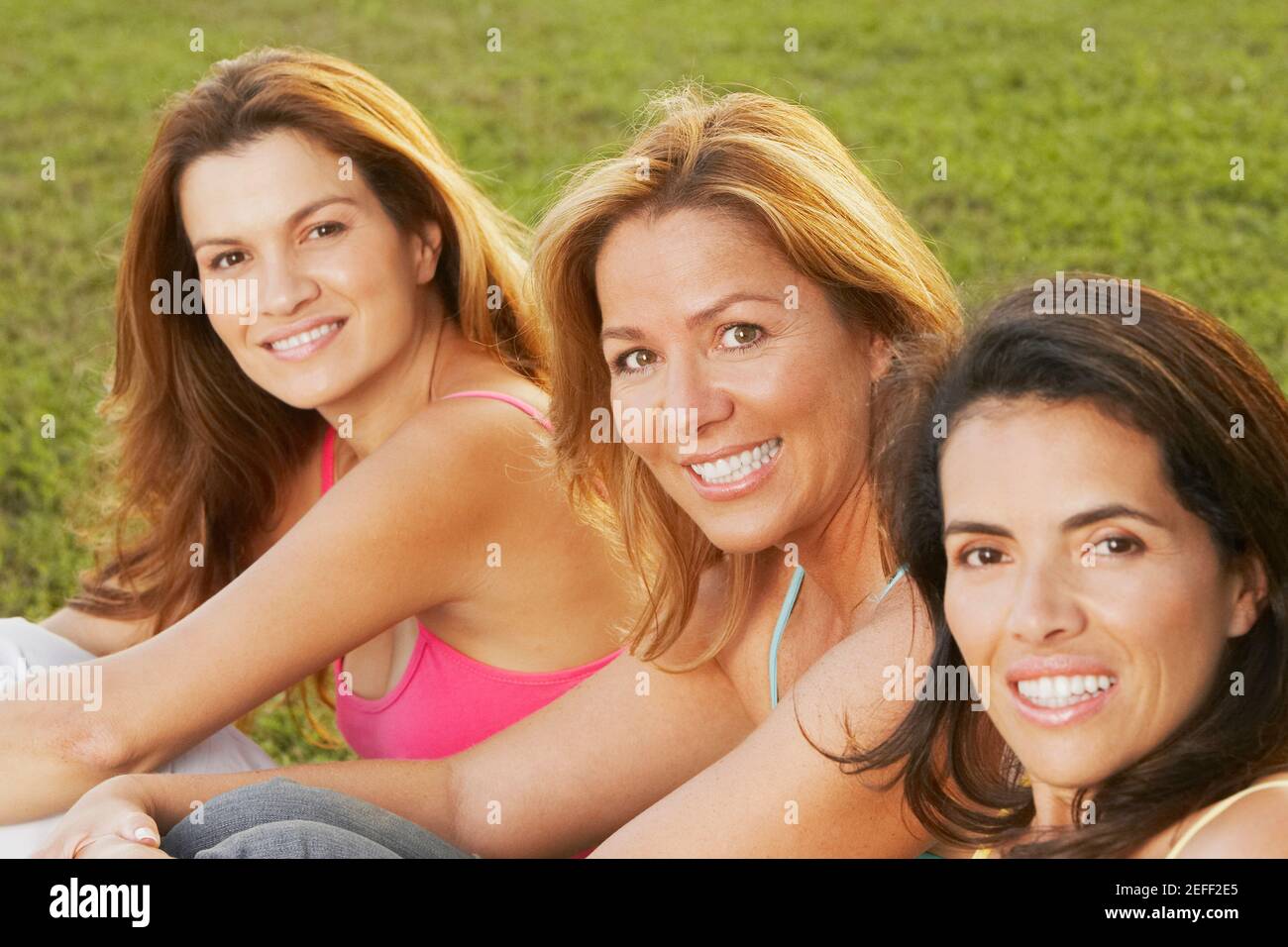Portrait of two mid adult women and a mature woman smiling Stock Photo