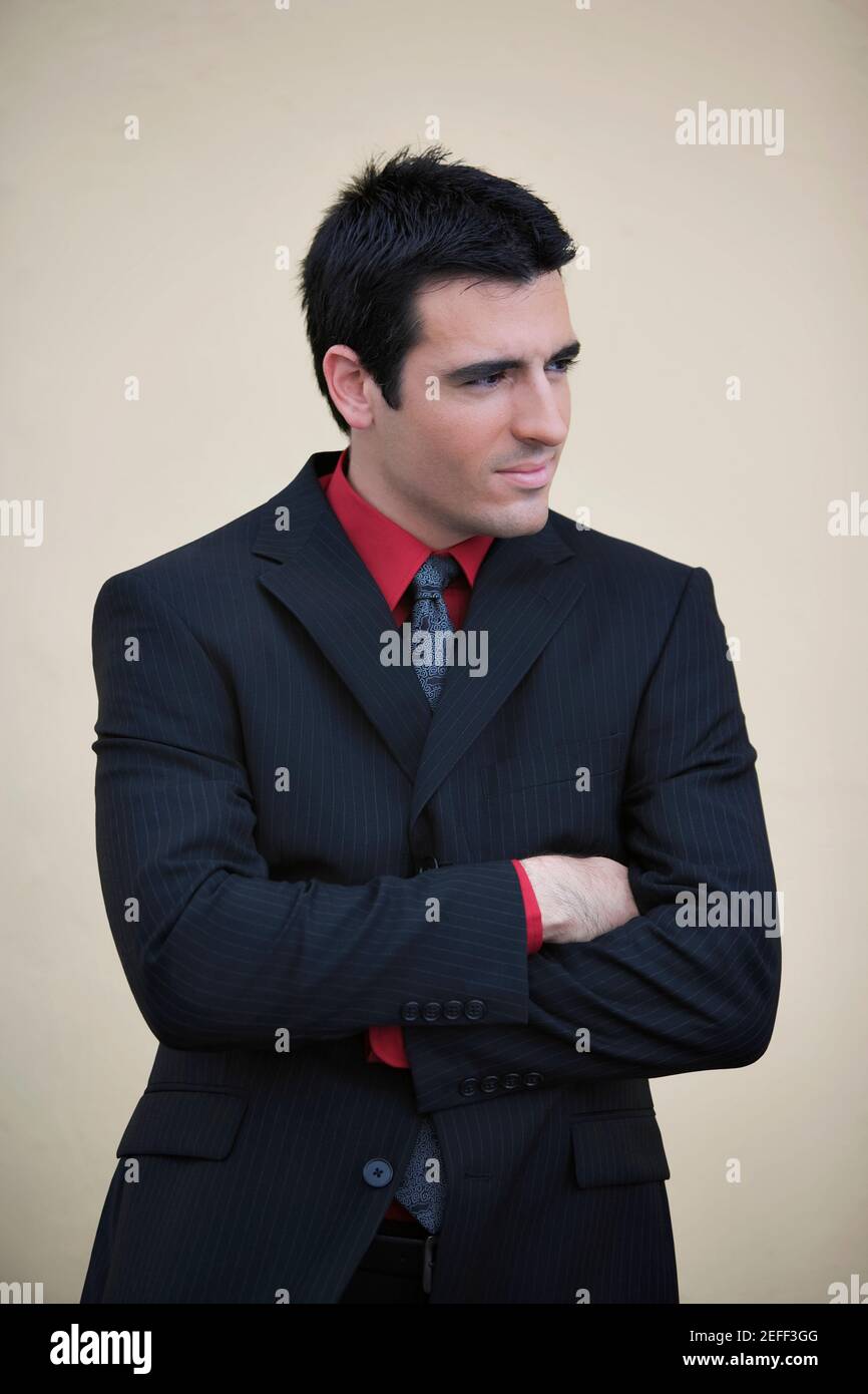 Businessman standing with his arms crossed and smiling Stock Photo - Alamy