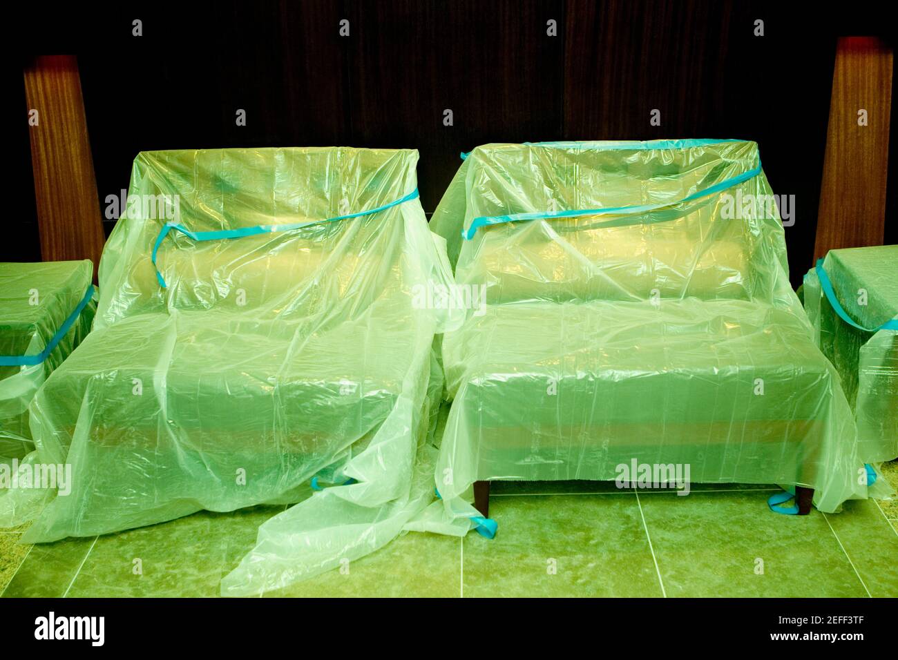 Chairs covered with plastic in a store Stock Photo