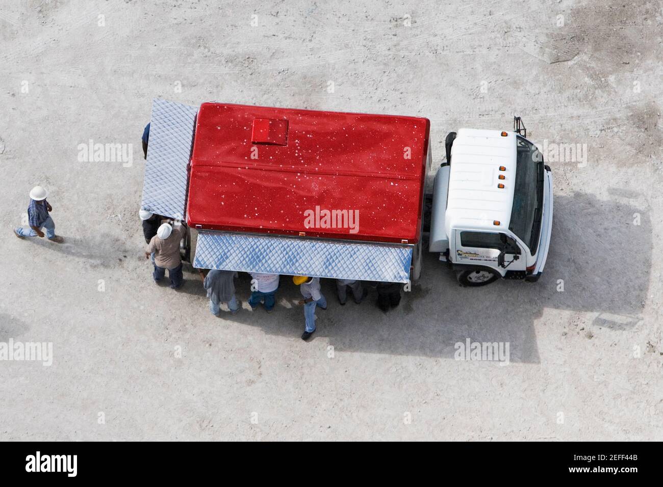 High angle view of construction workers standing near a semi truck Stock Photo