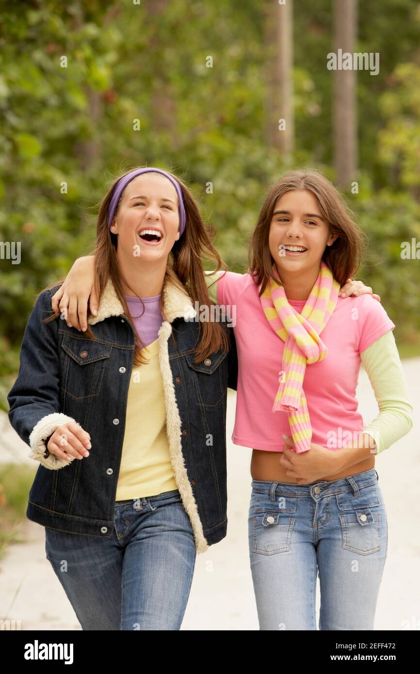 Two girls with their arms around each other Stock Photo