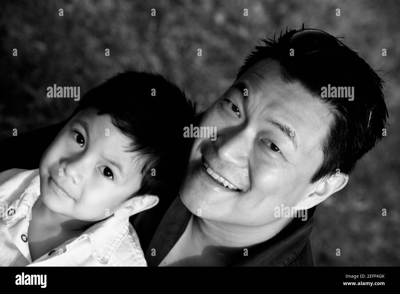 Portrait of a mid adult man with his son smiling Stock Photo