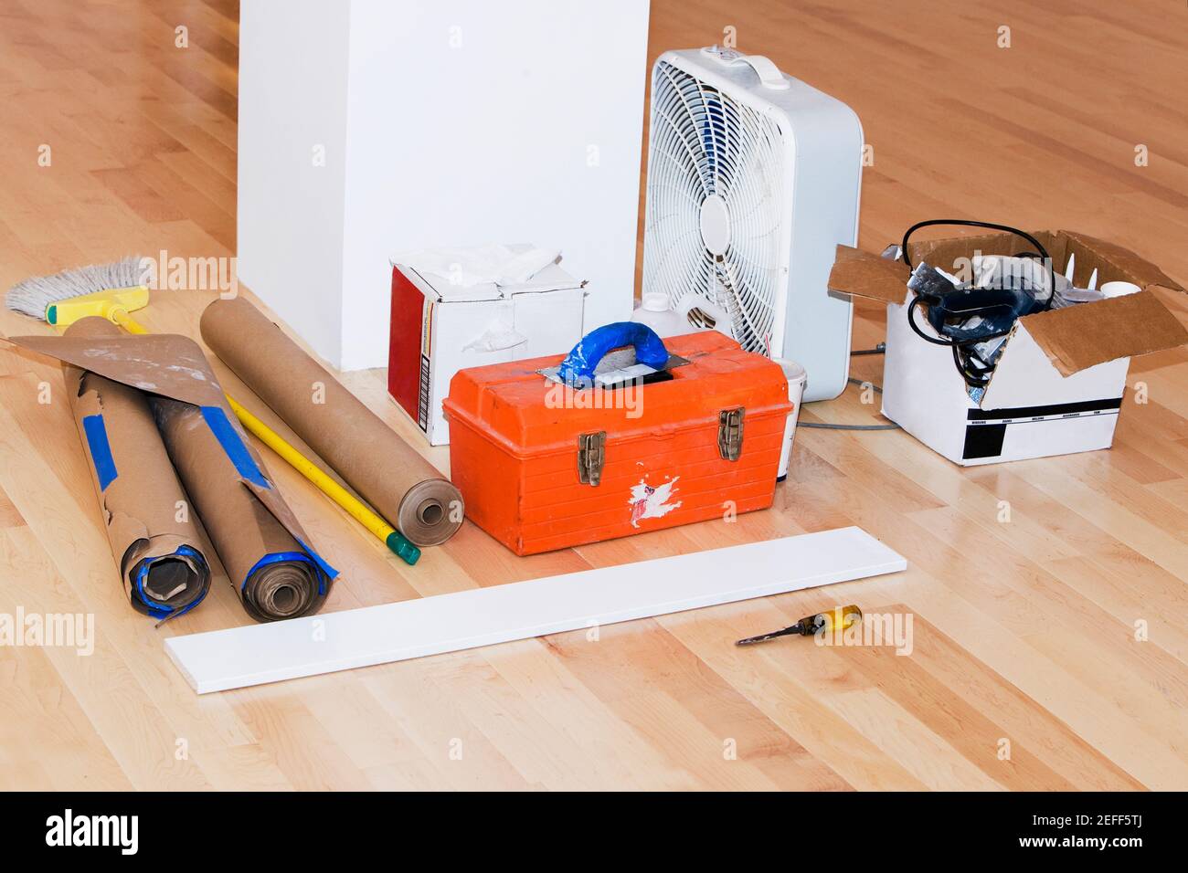 Toolbox with wallpapers and an electric fan on the floor Stock Photo