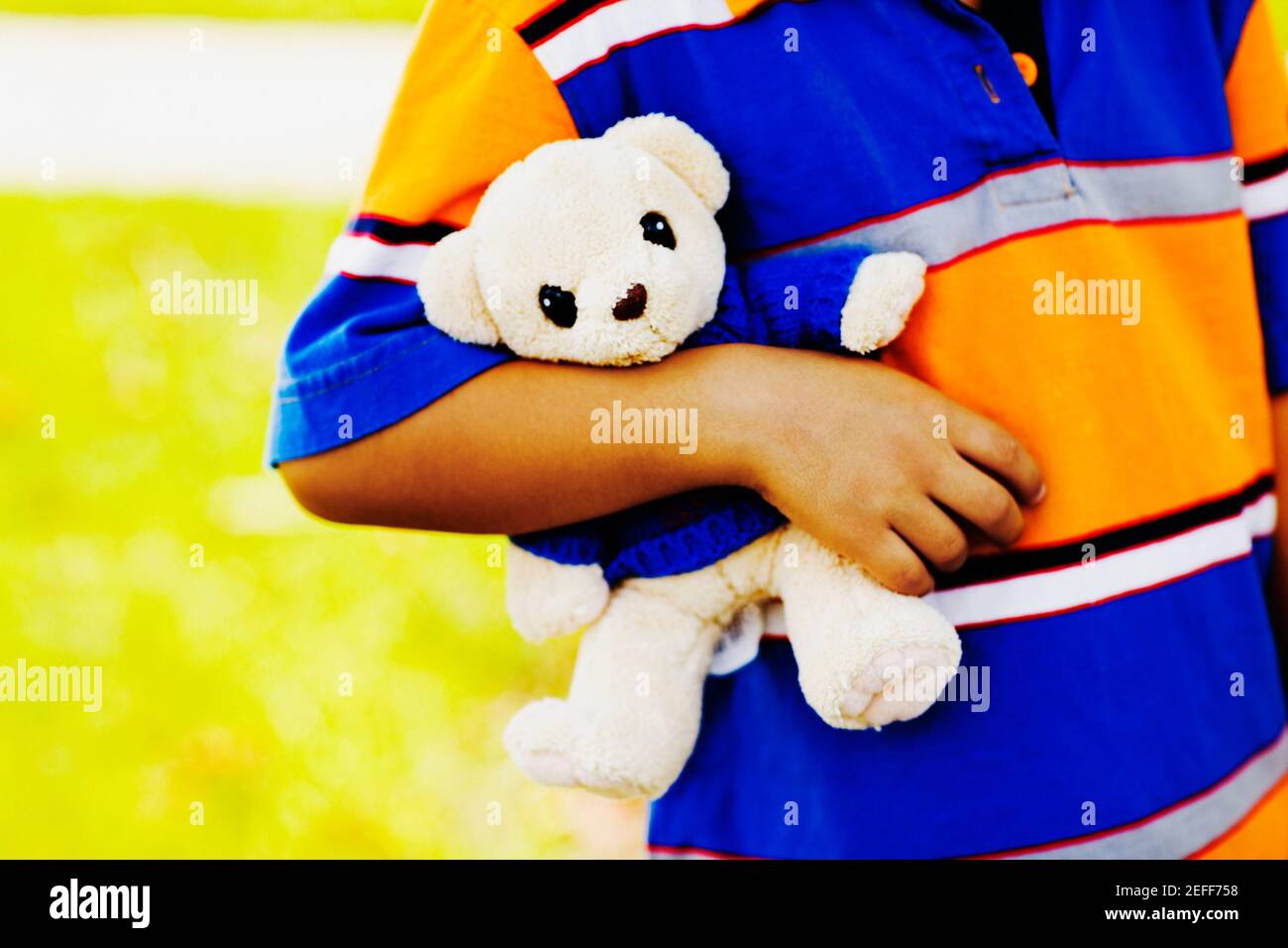 Mid section view of a boy holding a teddy bear Stock Photo - Alamy