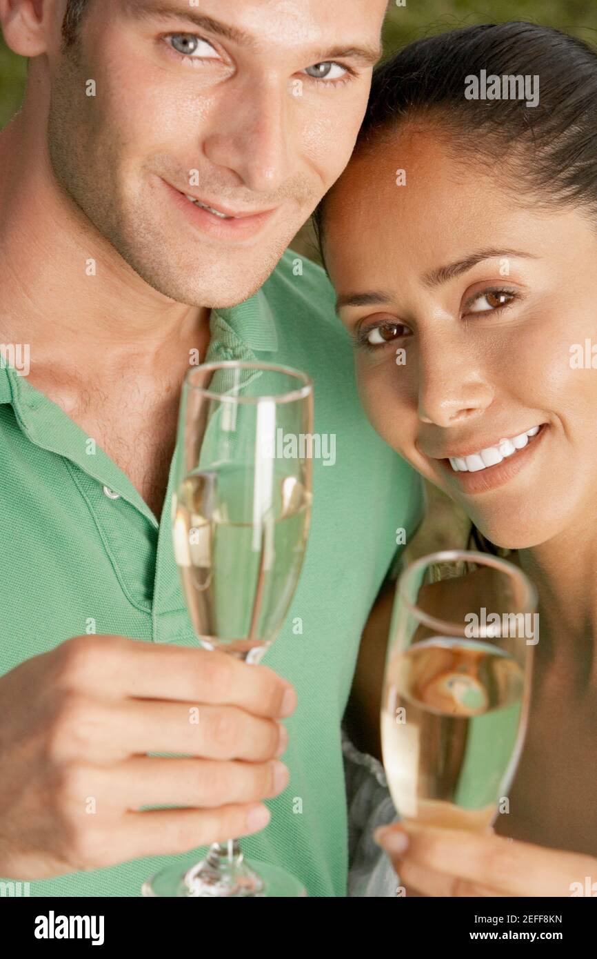 Portrait of a young couple holding champagne flutes Stock Photo