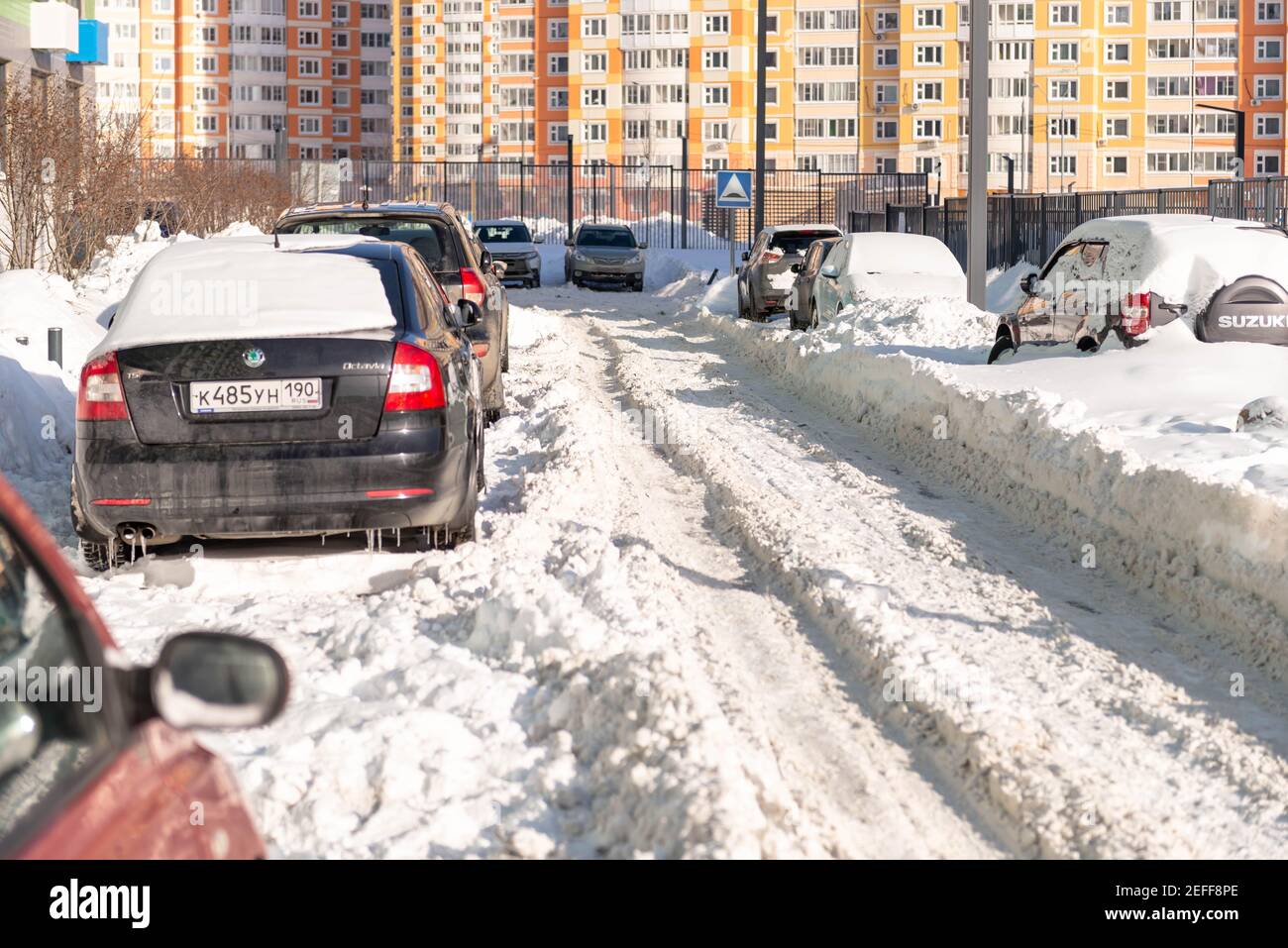 Moscow. Russia. Snowfall in February. Driveways in yards after a snowfall. In the city after a snowfall, wheel ruts. The consequences after a historic Stock Photo
