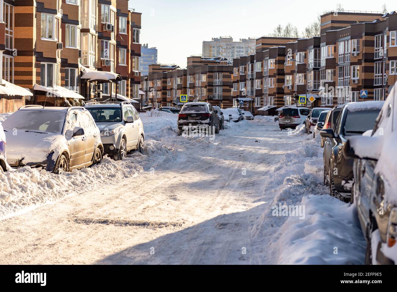 Moscow. Russia. Snowfall in February. Driveways in yards after a snowfall. In the city after a snowfall, wheel ruts. The consequences after a historic Stock Photo