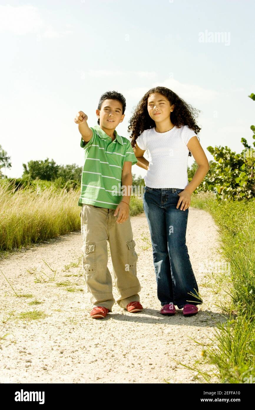 Boy and a girl standing in a walkway Stock Photo