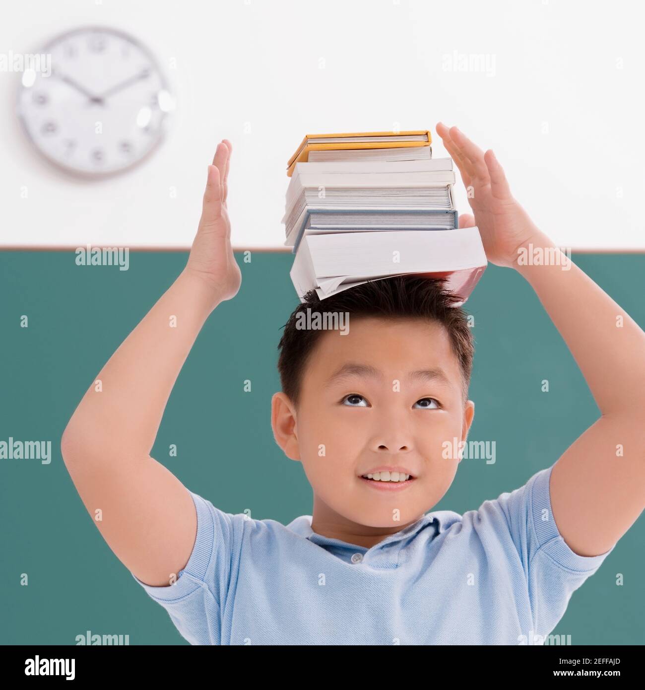 Children balancing book on head hires stock photography and images Alamy
