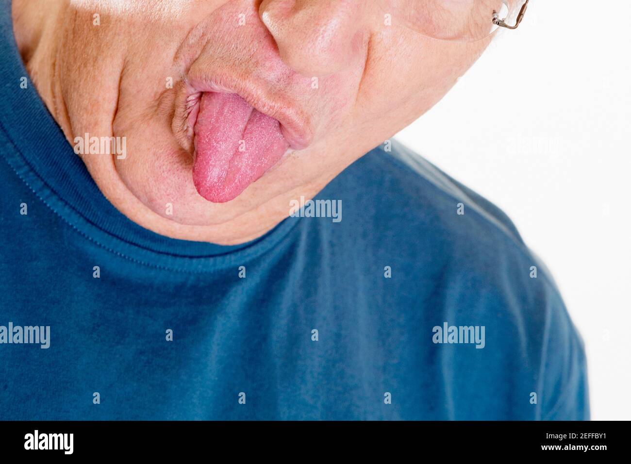 Close-up of a senior man sticking his tongue out Stock Photo