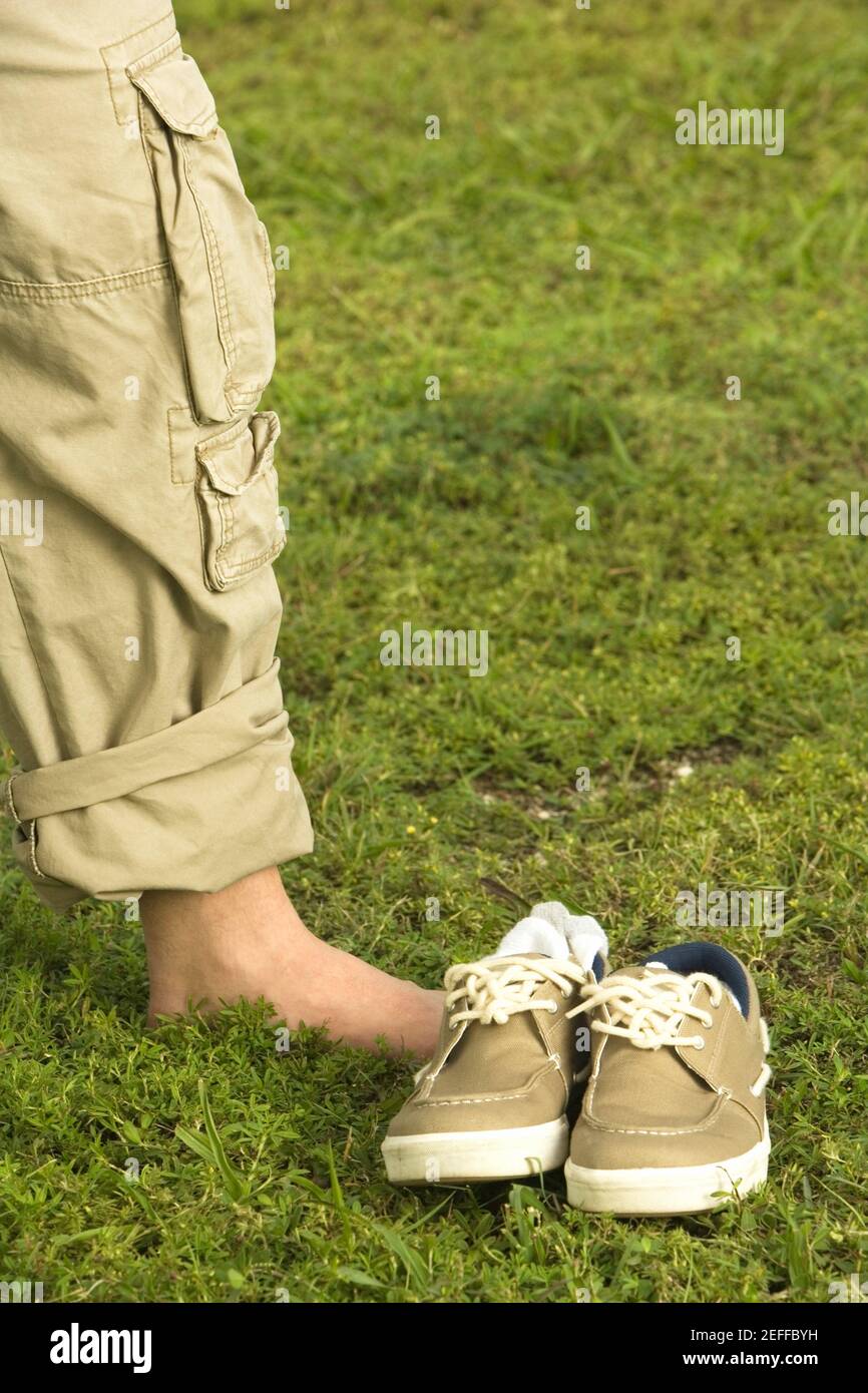 Low section view of a mid adult man standing on the grass Stock Photo ...