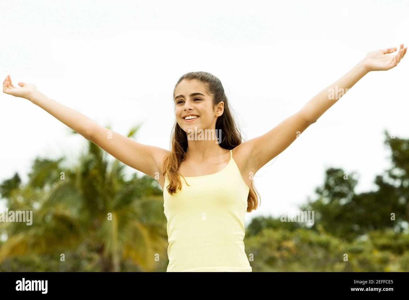 Girl standing with her arms outstretched Stock Photo - Alamy