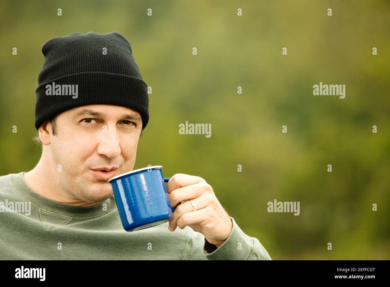 Portrait of a mature man drinking from a mug Stock Photo