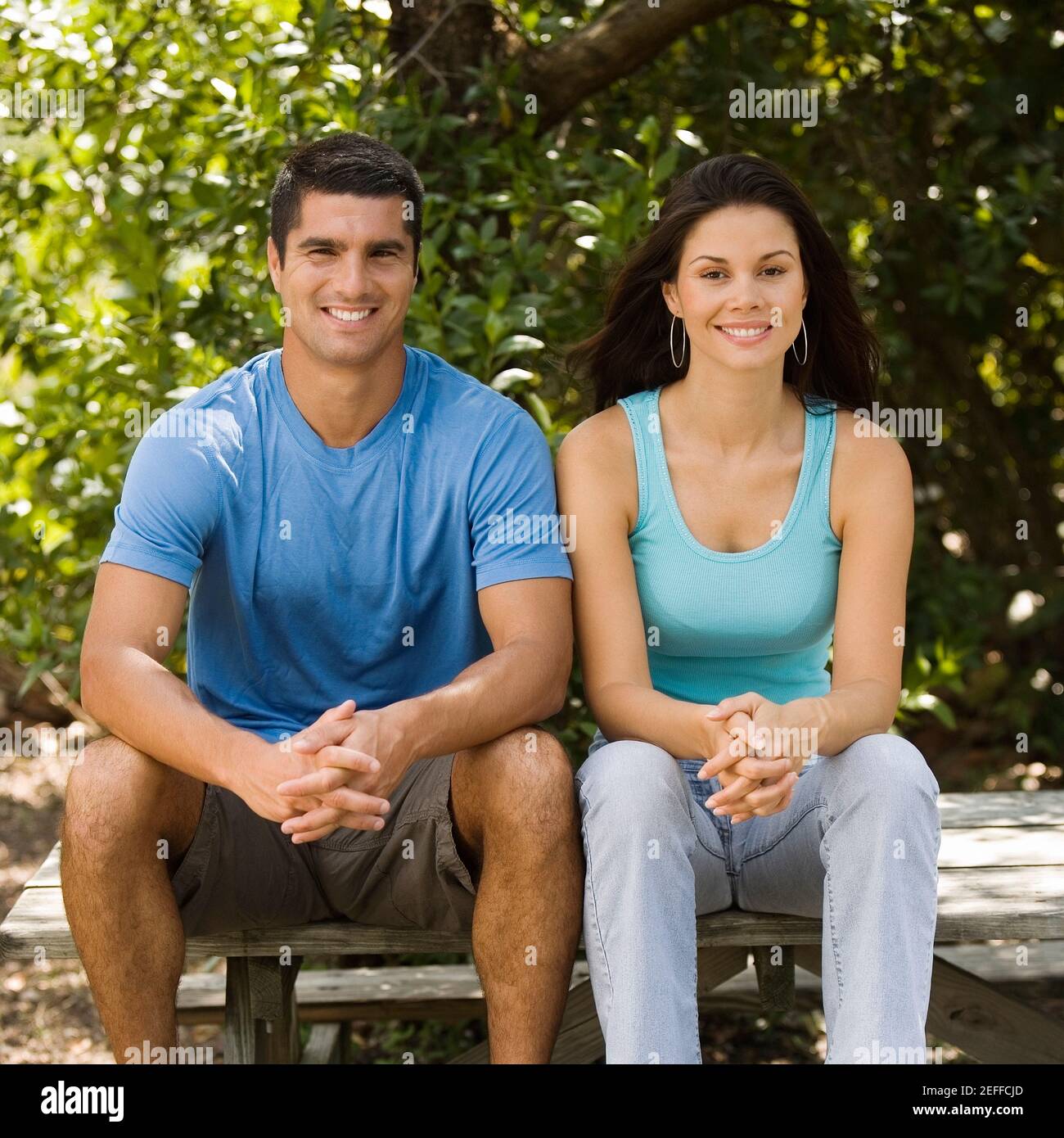 Portrait of a young woman and a mid adult man sitting together Stock ...