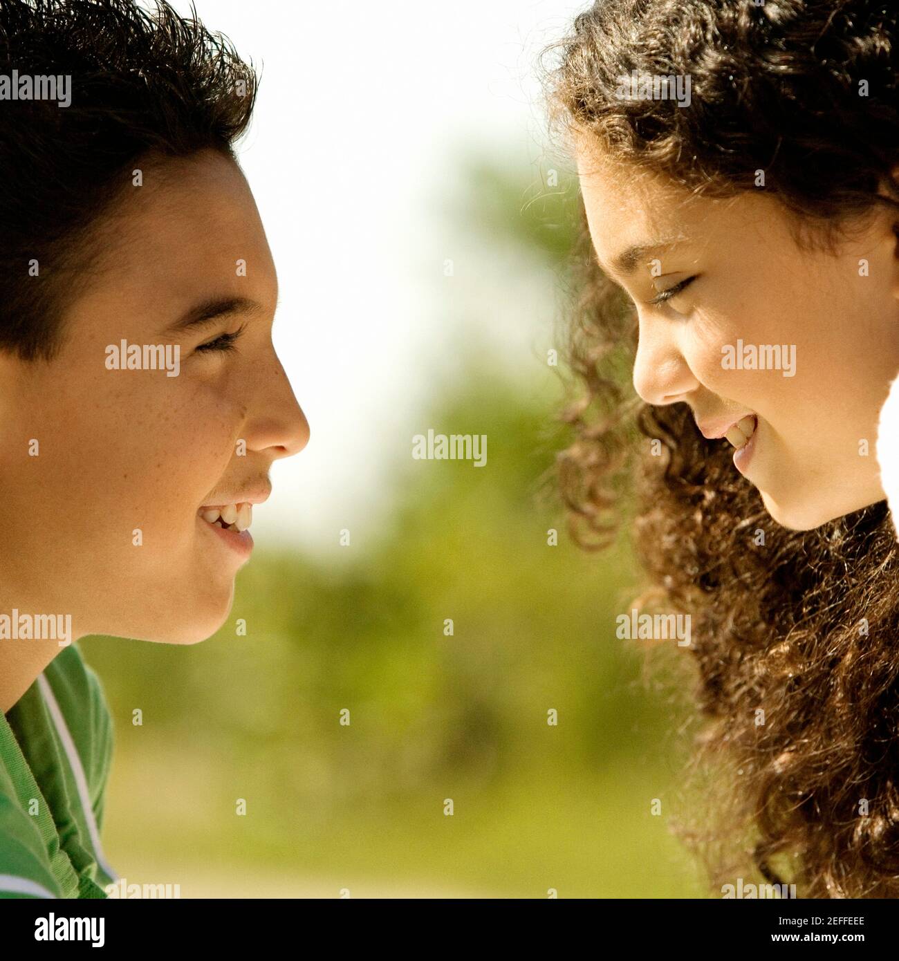 Close-up of a boy and a girl looking at each other smiling Stock Photo