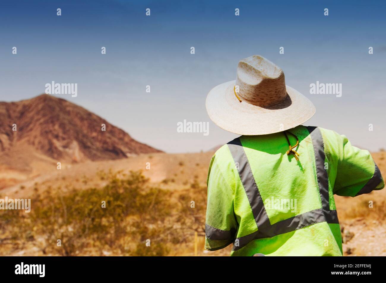 Rear view of a construction worker standing at a construction site Stock Photo