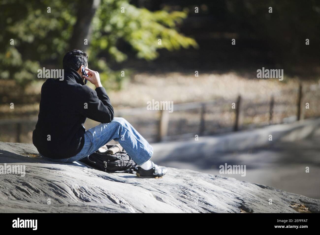 Rear view of a man talking on a mobile phone Stock Photo - Alamy