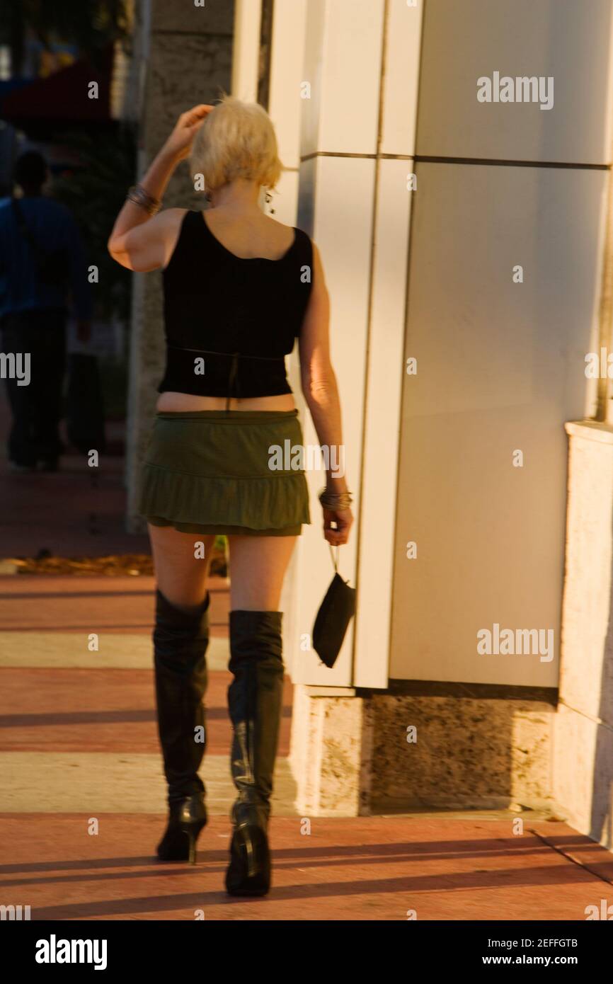 Woman in short skirt walking hi-res stock photography and images - Alamy