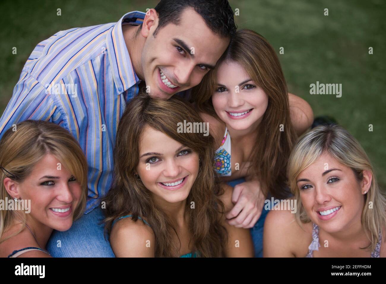 Portrait of four young women smiling with a young man Stock Photo - Alamy