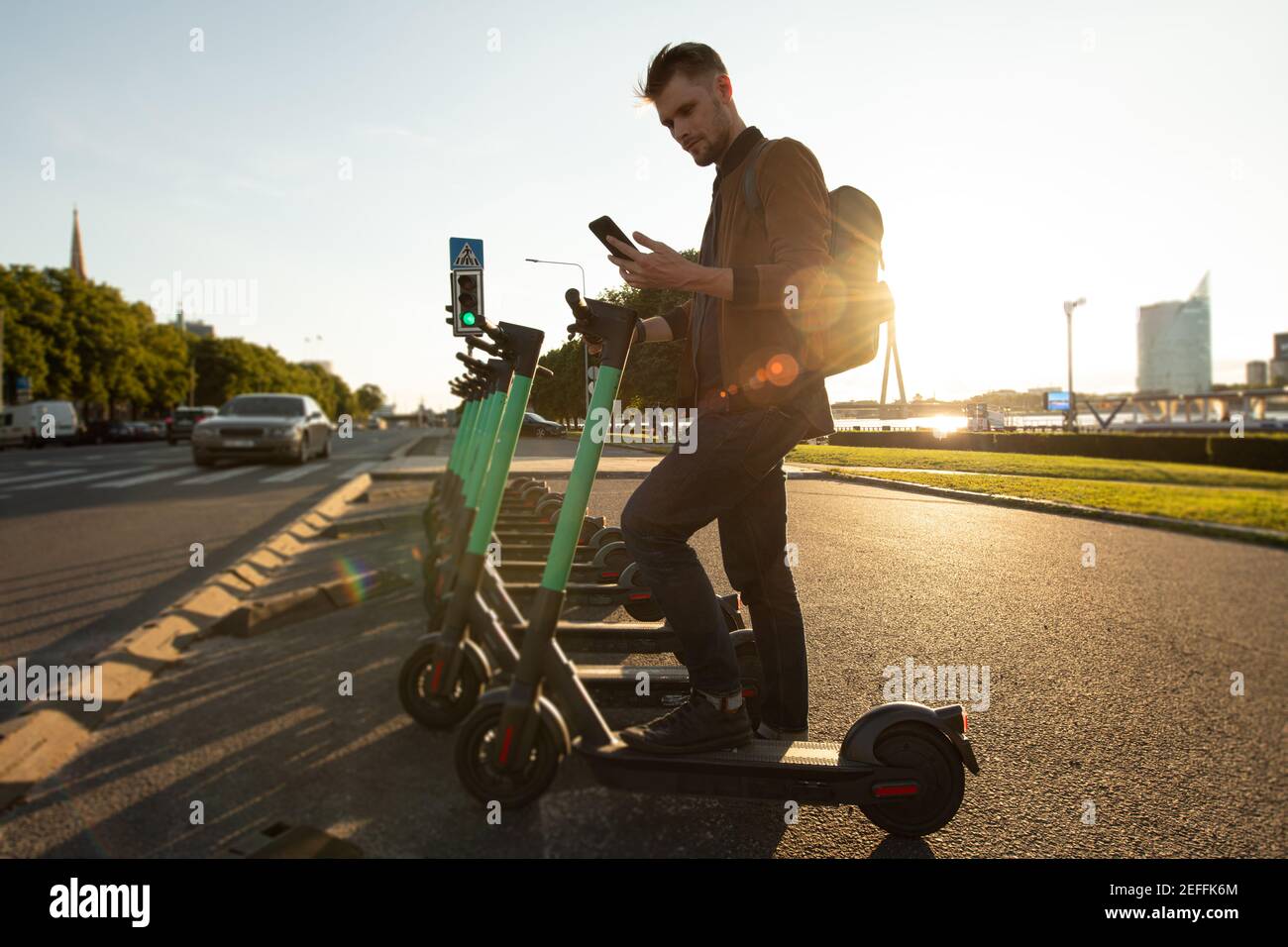 Ecology transportation and sustainability in cities. Person using electric scooter new way city mobility. Green transportation climate neutral goals Stock Photo
