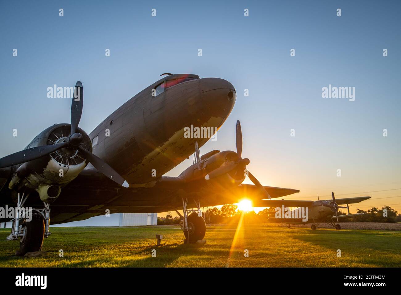 Sunsetting behind  DC-3 sitting outside of Massey Airport, Massey, MD Stock Photo