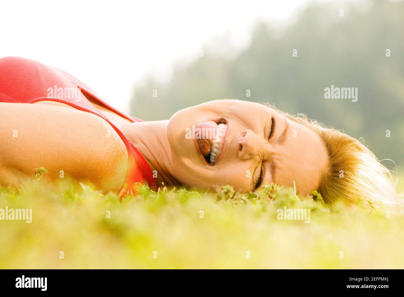 Portrait of a mid adult woman lying on the grass Stock Photo