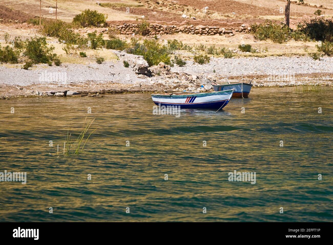 Boats in a lake, Lake Titicaca, Puno, Puno Region, Puno Province, Peru Stock Photo
