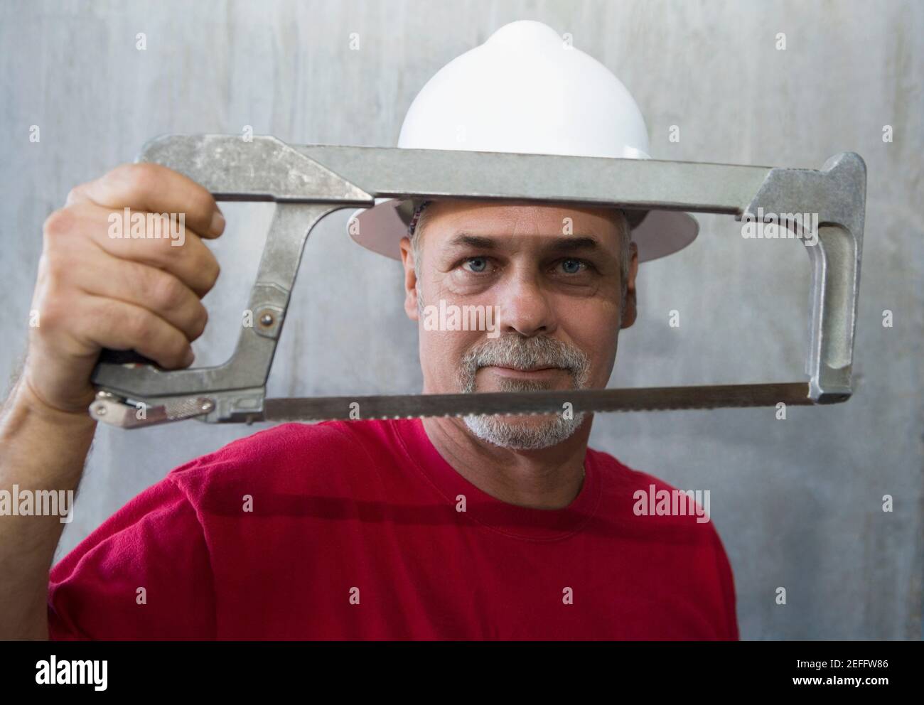 Portrait of a mature man holding a coping saw Stock Photo