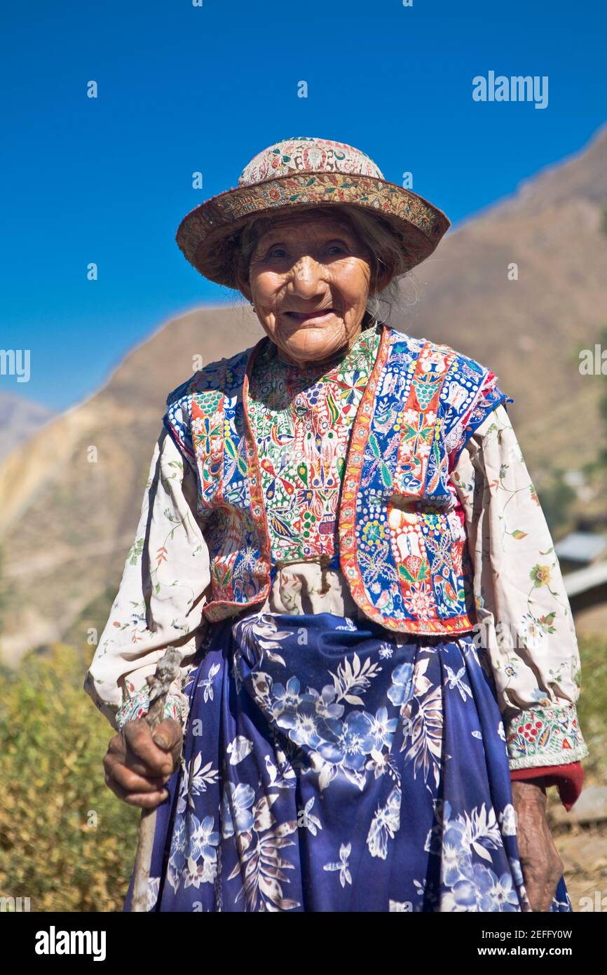 Portrait of a senior woman holding a cane and standing, Coshnirua, Peru Stock Photo