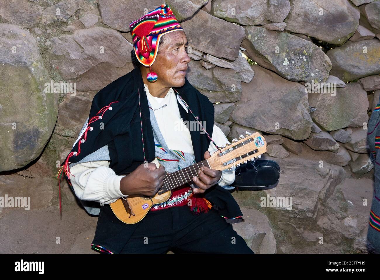 Close-up of a senior man playing a ukulele, Taquile Island, Lake Titicaca,  Puno, Peru Stock Photo - Alamy