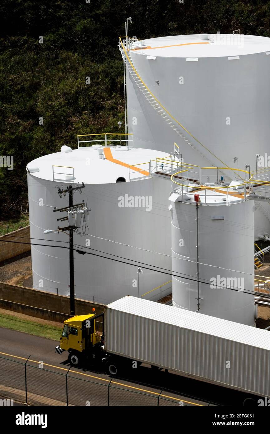 High angle view of a semi-truck on the road with storage tanks in the background Stock Photo