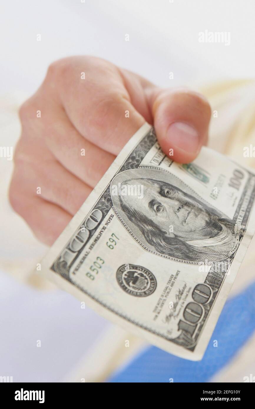 Close up of a personŽs hand holding an American one hundred dollar bill Stock Photo