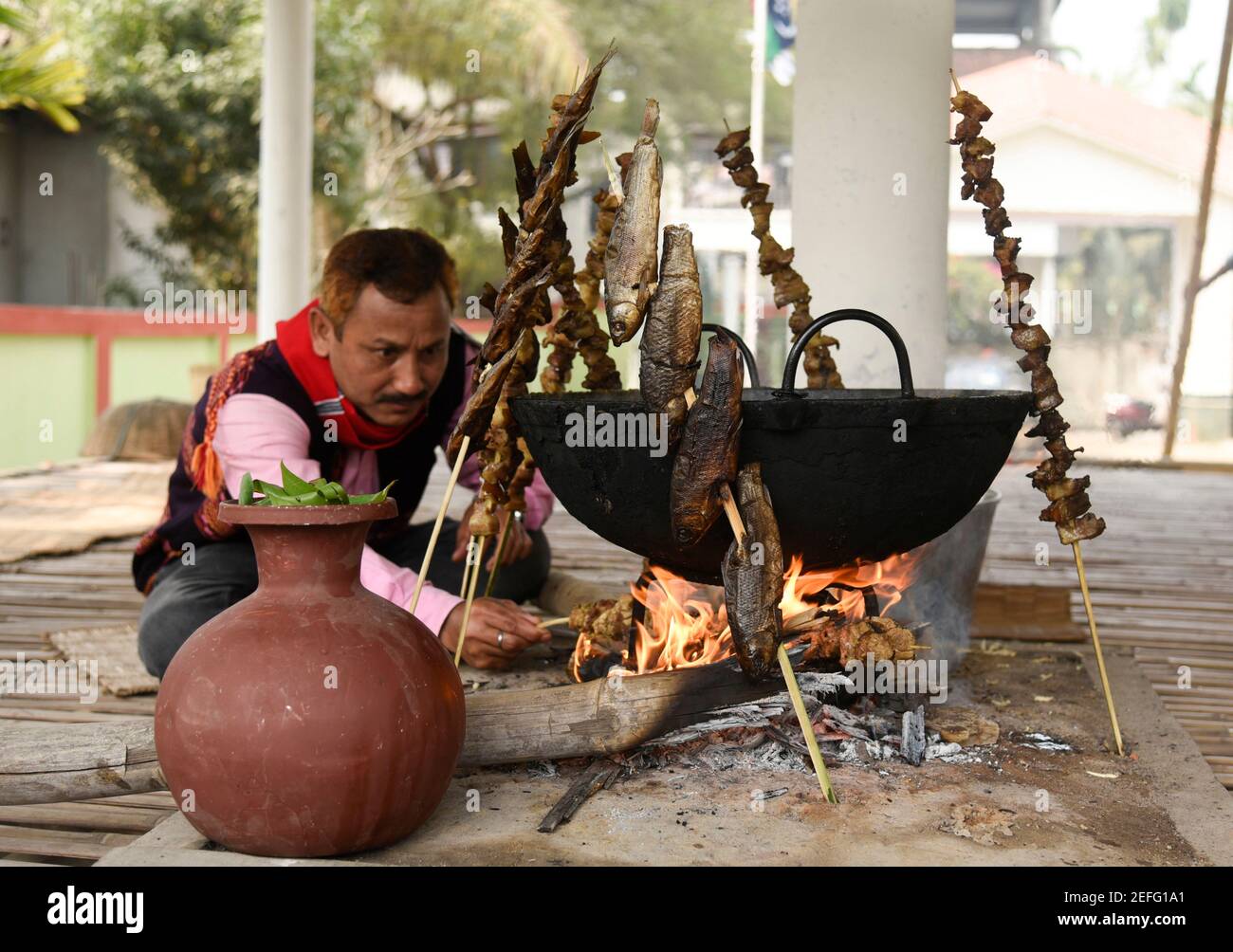 Guwahati, India. 17th Feb, 2021. Mising tribal people preparing traditional food during Ali-Aye-Ligang festival in Guwahati, India on 17 February 2021. Ali-Aye-Ligang, the main harvest festival of the ethnic Mising community people, this spring festival associated with agriculture, especially with the beginning of the Ahu paddy cultivation. Credit: David Talukdar/Alamy Live News Credit: David Talukdar/Alamy Live News Stock Photo