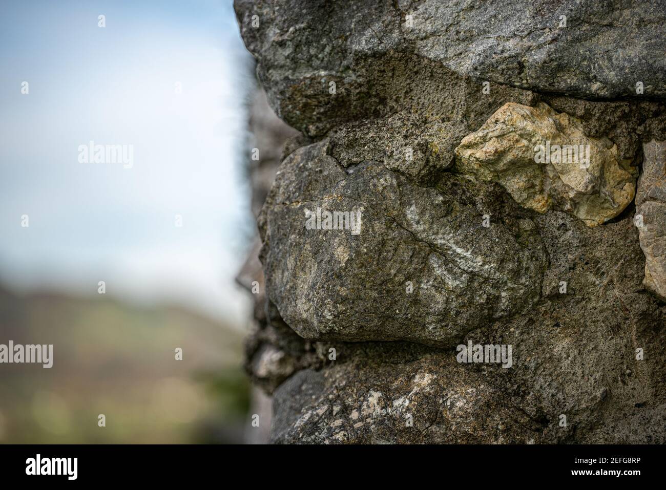 Texture of an old stone wall suitable for photo editing and wallpaper - the  blue summer sky can be seen in the background Stock Photo - Alamy