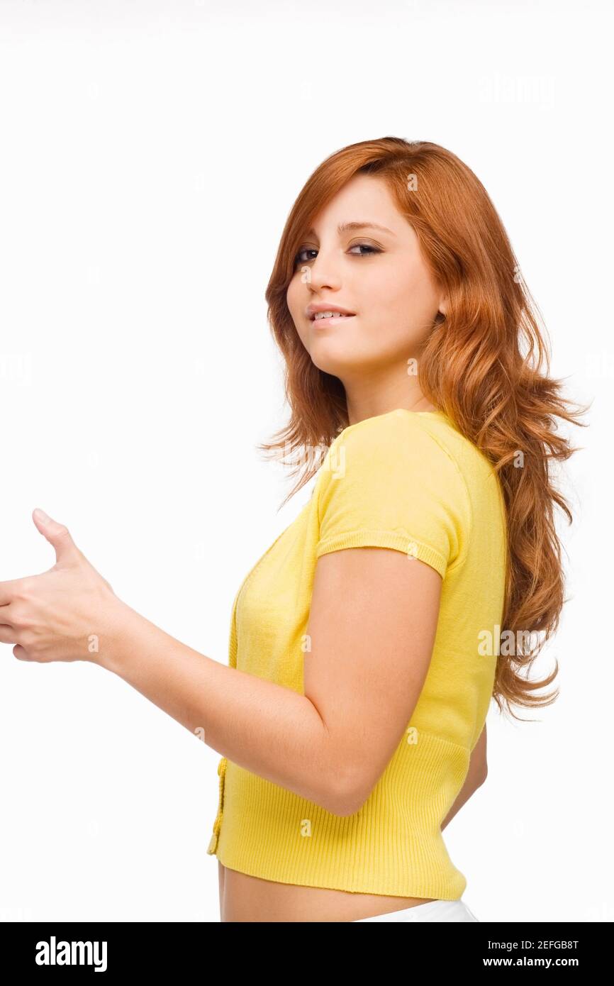 Portrait of a young woman showing a thumbs up sign and smiling Stock ...
