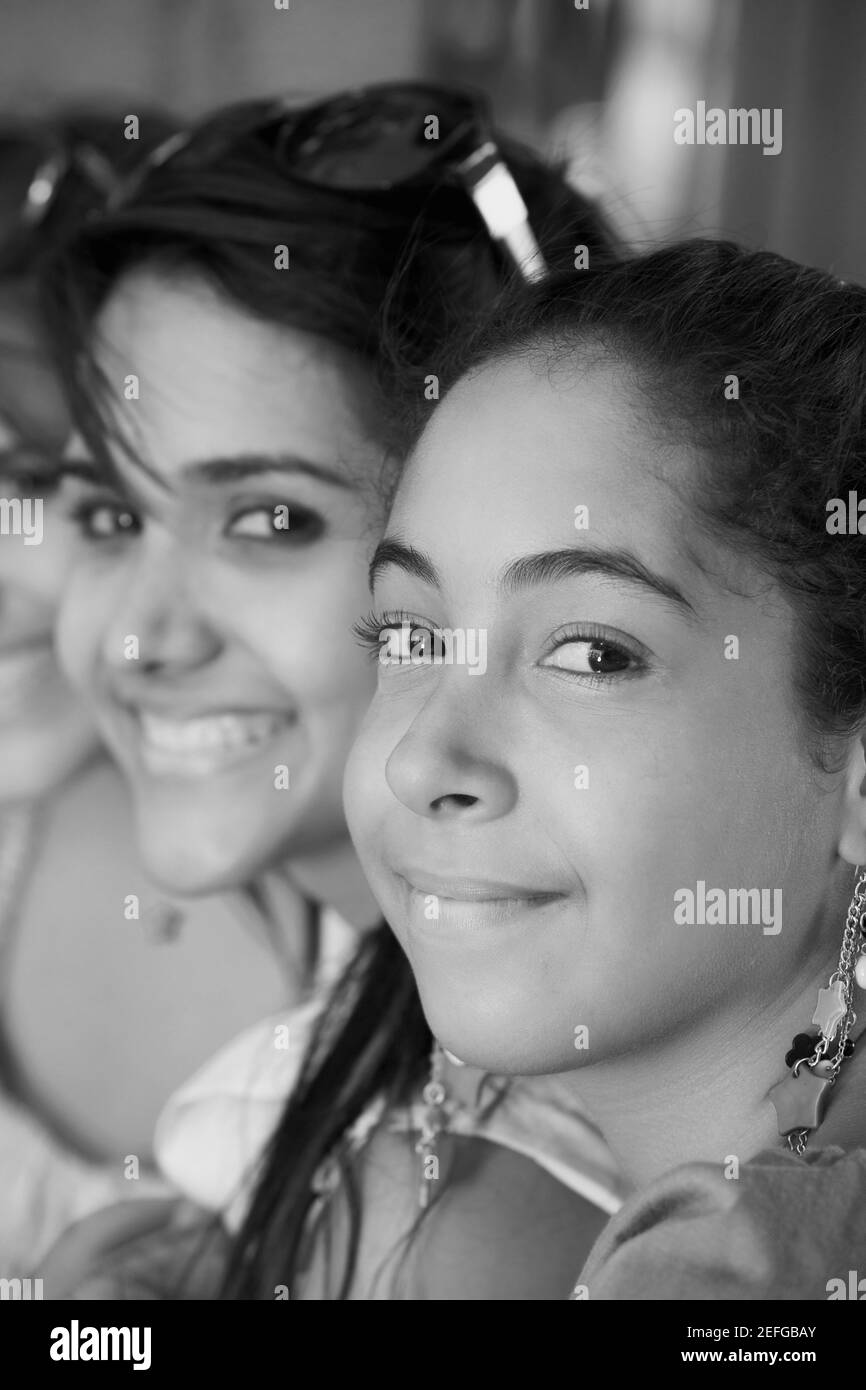 Portrait of a young woman grinning with her two friends smiling beside her Stock Photo