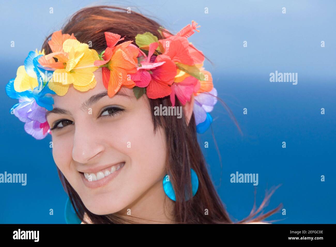 Portrait of a young woman wearing lei and smiling, Diamond Head, Waikiki Beach, Honolulu, Oahu, Hawaii Islands, USA Stock Photo
