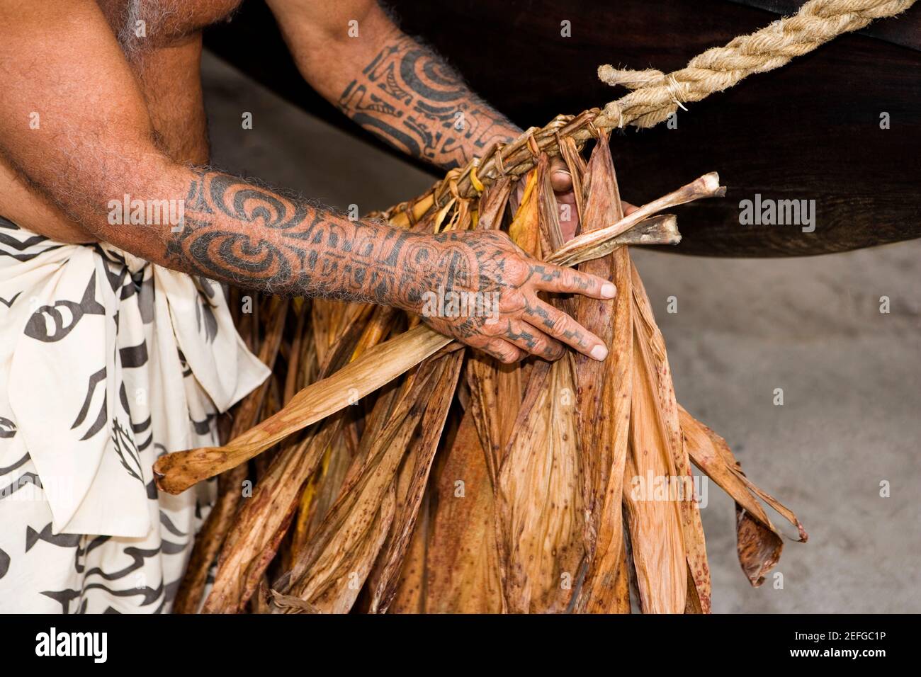 Micronesia Rope Making Mid section view of a man making a rope, Puuhonua O Honaunau National ...