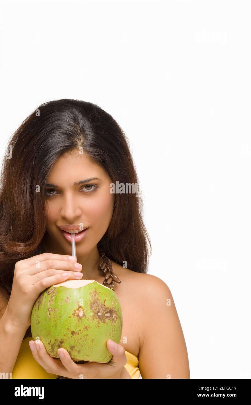 Portrait of a young woman drinking coconut milk Stock Photo Alamy