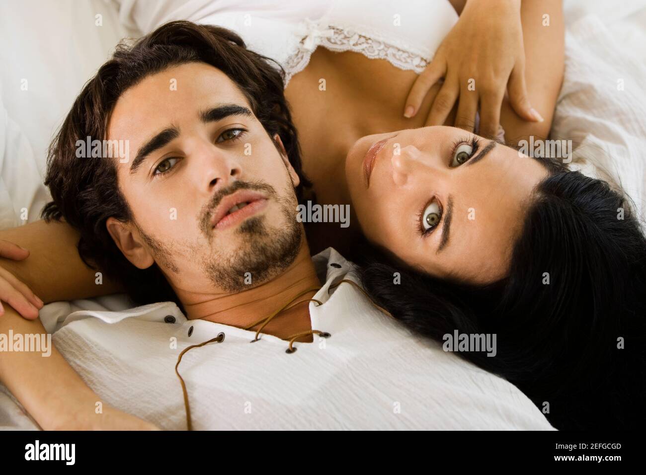 Portrait of a young couple lying on the bed Stock Photo