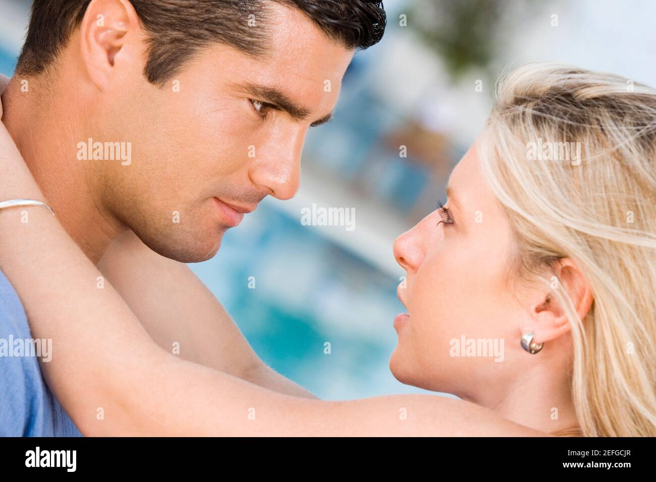 Side profile of a young woman embracing a mid adult man Stock Photo - Alamy