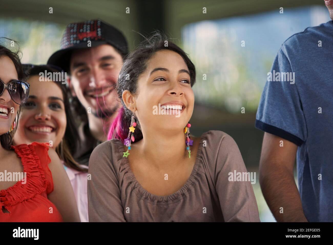 Close-up of three young women and a young man smiling Stock Photo - Alamy