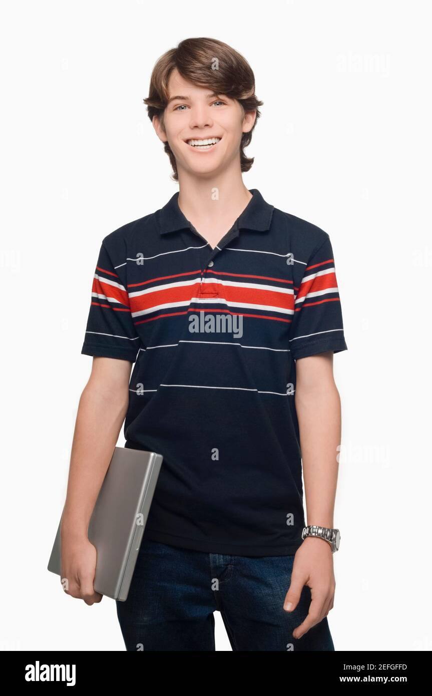 Portrait of a teenage boy holding a laptop and smiling Stock Photo - Alamy