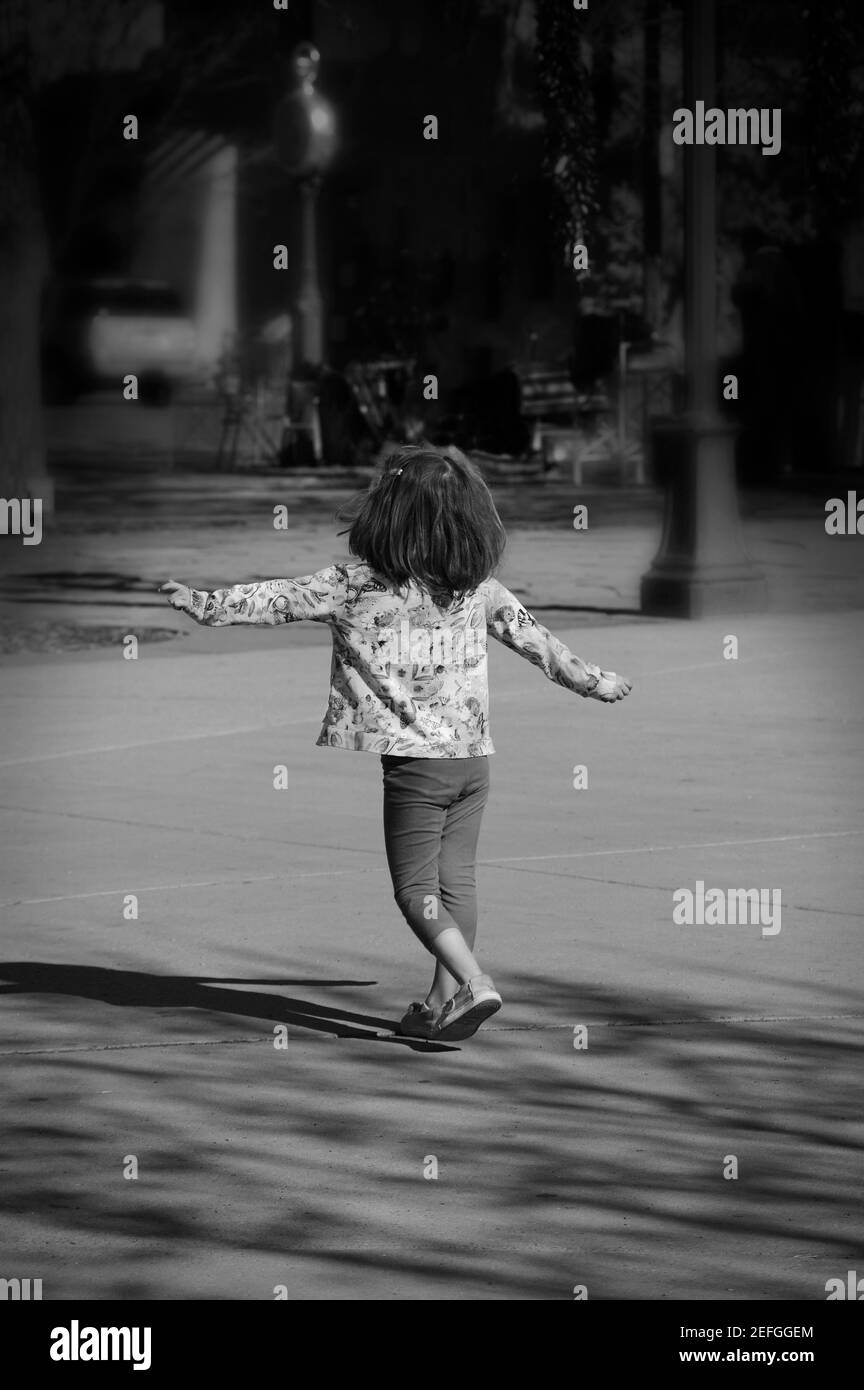 A young girls dances to music in a park in Santa Fe, New Mexico USA. Stock Photo