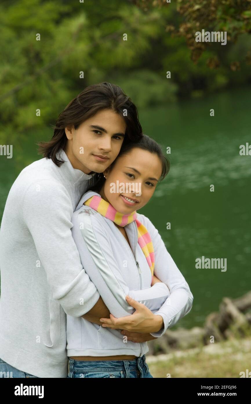 Side profile of a young man embracing a young woman Stock Photo - Alamy