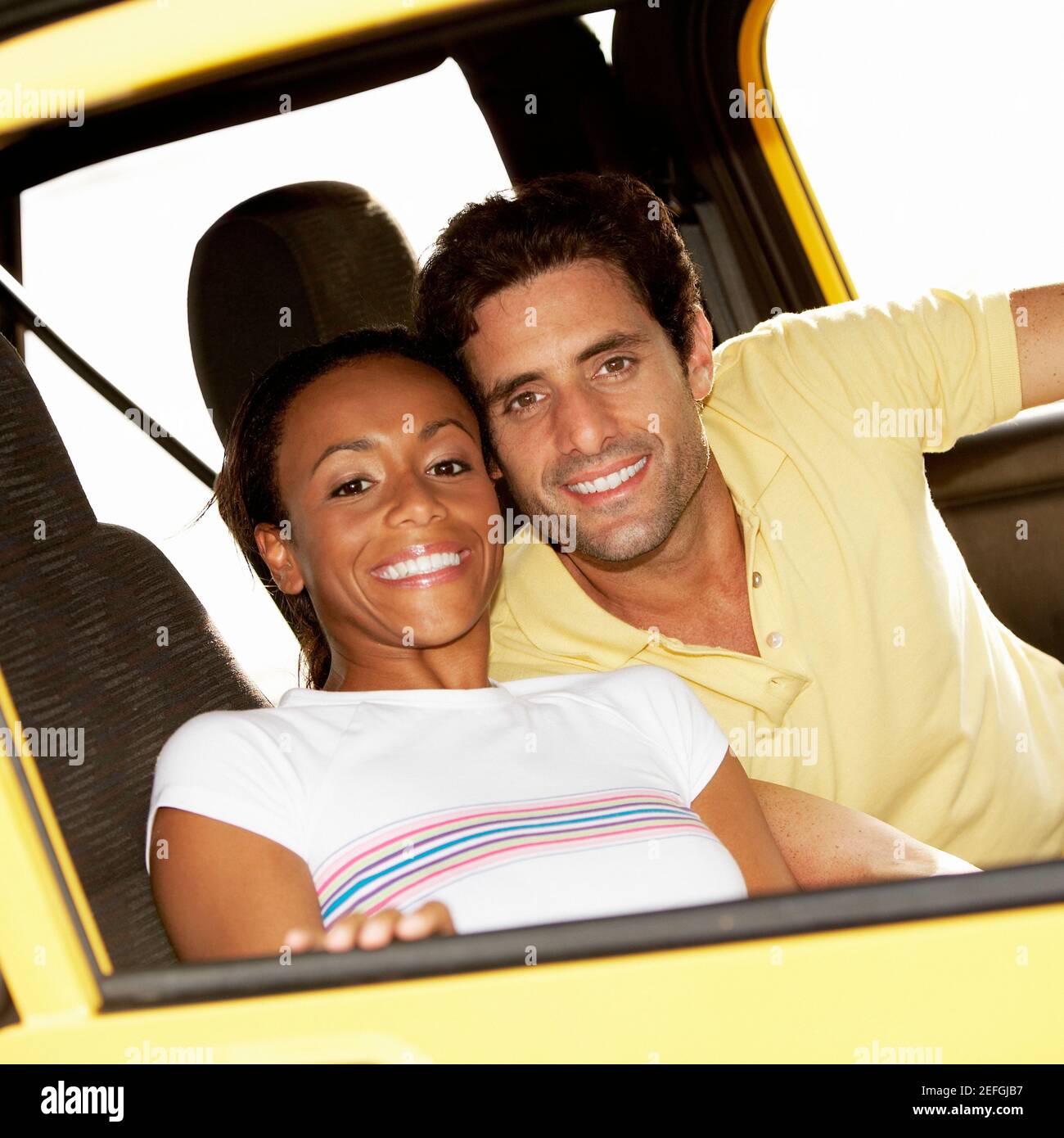 Portrait of a young woman and a mid adult man sitting in a jeep Stock ...